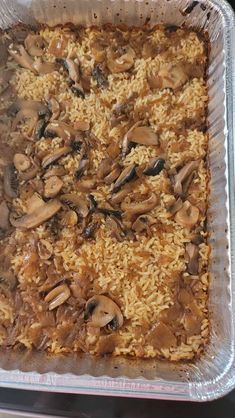 a casserole dish filled with rice and mushrooms