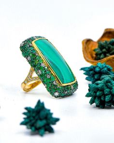 60-carat Malachite Surrounded By 10.18-carat Lab Emeralds and 1.92-carat Lab Diamonds Ring with 14K Gold STONE NAME: Malachite & Lab Emerald & Lab Diamonds PRODUCT ID: R - 16 WEIGHT: 60 Carat SHAPE: Emerald Cut Stone QUANTITY: 1 Piece COLOR: Green/Gold ORIGIN: Manufacture in India Natural/Lab-Created : 100% Natural Stone QUALITY: AAA+ { FINE } Gemstone Size:- - - Material:- 925 Sterling Silver, 14 K Gold For any doubt and query please contact with us to feel free. Worldwide SHIPPING POLICY. Akgemsandjewels International Buyers - Please Note: Import duties, taxes, and charges are not included in the item price or shipping charges. These charges are the buyer's responsibility. Please check with your country's customs office to determine what these additional costs will be prior to buying NO Luxury Green Rings With Gemstone Accents, Luxury Green Emerald Ring With Gemstone Accents, Luxury Green Emerald Ring, Luxury Green Gemstones For Anniversary, Luxury Tsavorite Gemstones For Anniversary, Luxury Green Multi-stone Emerald Ring, Fine Jewelry With Round Malachite, Luxury Malachite Ring, Luxury Green Cabochon Jewelry