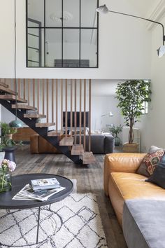 a living room filled with furniture and a stair case