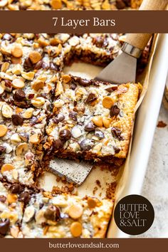 These delicious and simple 7 Layer Bars are the definition of indulgence. These bars come together in a matter of minutes and are layered with buttery graham crackers, gooey chocolate, rich butterscotch, toasty coconut, toasted nuts, and caramel-like goodness. There is no secret as to why these treats are a crowd favorite — they are simply magical! Christmas 7 Layer Cookie Bars, Layer Bars Recipe, 7 Layer Cookies, Graham Cracker Butter, Magic Cookie Bar Recipe, Seven Layer Bars, 7 Layer Bars, Magic Cookie Bars, Layer Bars