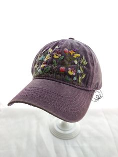 a purple baseball cap with flowers on it