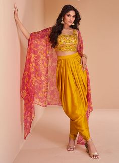 Yellow satin readymade dhoti set cape suit 5352 Crop top with Dhoti set and shrug style cape suit 3 pcs set. Crop top and Dhoti in satin with original mirror work embroidery, resham work and cape suit in organza fabric with digital print work. Desc:  Style : Dhoti Style crop top cape suit  Color :Yellow  Fabric : Satin,Organza Wash Care : Dry clean Sleeve Style : cape ,Work: embroidery and digital print Long Sleeves : Done only in Custom Stitch Sleeves Lining : Done only in Custom Stitch Bust Size : Free size 40 to 42 Inches Occasion : Wedding   Festival   Christmas   Diwali   Sangeet   Reception   Ceremonial   Dussehra. With Express Free Shipping and Custom Stitching, Buy Indian Party wedding and bridal Anarkalis Yellow satin readymade dhoti set cape suit 5352 online in USA, UK Suit With Shrug, Dhoti Style Dresses, Dhoti Salwar Suits, Haldi Outfit, Diwali Outfits, Gaun Fashion, Bollywood Outfits, Yellow Satin, Patiala Salwar