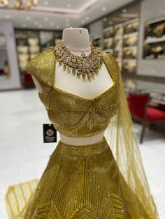 Elevate your bridal look with our Metallic Yellow Bridal Lehenga BL-121! The stunning metallic yellow color, beautifully complemented by intricate foil work, will make you stand out on your special day. Make a bold statement and feel like a princess with this breathtaking lehenga! Fabric: Net with Raw Silk Lining! WASH CARE INSTRUCTIONS - Please Dry clean only when it is applicable! Ready to Ship! Net Choli Designs Latest, Gold Semi-stitched Dresses For Party Wear, Gold Gown With Gold Embroidery For Reception, Gold Embroidered Gown For Reception, Festive Gold Gown With Gold Embroidery, Gold Sharara With Gold Embroidery For Reception, Semi-stitched Gold Party Dress, Gold Party Wear Gown With Dupatta, Gold Anarkali Set With Zari Work For Reception