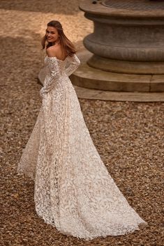 a woman in a white dress is standing on the ground with her arms behind her back