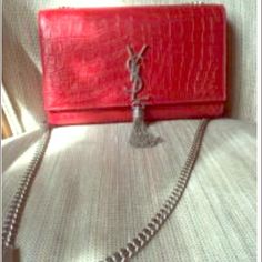 Red Saint Laurent Bag Red tassle Saint Laurent bag.  Never worn. Originally 1550 and now selling for 1000. It's a beautiful bag. Saint Laurent Bags Mini Bags Designer Red Rectangular Shoulder Bag, Designer Red Pouch Shoulder Bag, Luxury Red Rectangular Shoulder Bag, Luxury Red Shoulder Bag, Luxury Red Pouch Bag, Luxury Red Clutch Bag, Luxury Red Bag With Dust Bag Included, Luxury Red Evening Bag, Elegant Red Evening Bag For Shopping