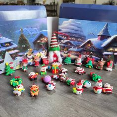 there are many small christmas toys on the table next to each other, including santa's helpers and snowmen