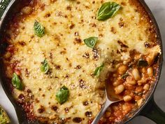 a skillet filled with baked beans and cheese