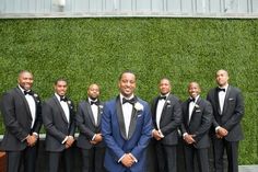 a group of men standing next to each other in tuxedos and bow ties