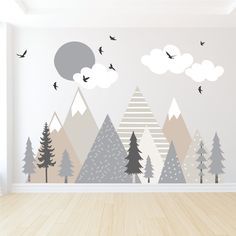 an empty room with some trees and birds in the sky on it's wall