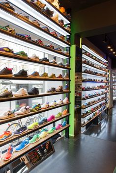 the inside of a shoe store filled with lots of different colored shoes on shelves next to each other