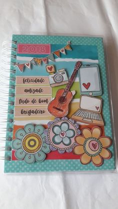 a notebook with an image of a guitar and flowers on it