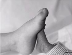 a black and white photo of someone's bare feet