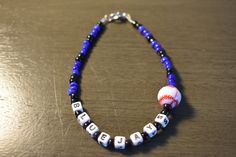 a baseball beaded necklace on a wooden table