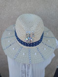 Our straw hats made with love, you saw the rhinestones, pearls with the denim jean wrapped around the hat. Great for a casual gathering with friends.  Measurements of the circumference 22 in. Length and width 14 in. Summer Hats With Rhinestones And Short Brim, Blue Summer Hat With Rhinestones, Blue Rhinestone Hat For Summer, Summer Straw Hat, Painted Hats, Jean Material, Friends Gathering, Straw Hats, White Hat