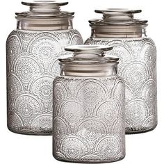 three glass canisters with metal lids