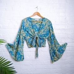 Bell Sleeve Plus Size Tie Top, Bohemian Wrap Top, 3 Way  Tie Hippie Boho Blouse, Flare Sleeves, Paisley Print, 70s Top, Silk Retro Top This  Bell Sleeve Flare Tie Top is the perfect marriage of 70s-style boho chic and modern flare. With handmade butterfly sleeves and a three-way tie top, this top gives an elegant summer retro look that looks stunning in any size. Plus, its unique handmade construction ensures excellent craftsmanship for a truly one-of-a-kind piece. Handmade Material: 100 % Silk Vintage V-neck Top With Boho Print, Hippie Peasant Top With Boho Print For Festivals, Fitted V-neck Bohemian Peasant Top, Hippie Floral Print Peasant Top For Festivals, Blue Bohemian Printed Peasant Top, Hippie Festival Blouse With Boho Collar, Green Boho Print Hippie Top, Green Hippie Top With Boho Print, Green Hippie Tops With Boho Print