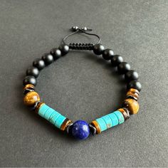 This Beautiful Bracelet Is A Combination Of Matte Black Onyx, Turquoise, Brown Tigers Eye And Centered With Lapis Lazuli And Accented White Black Hematite. All Those Beads Make The Most Powerful Protection Bracelet You Will Have. All Natural Gemstone 8mm Lapis, Onyx And Tigers Eye, 6mm Hematite And Turquoise. Adjustable Blue Beaded Bracelets With Natural Stones, Bohemian Blue And Black Beaded Bracelets, Adjustable Blue Beaded Bracelets With Black Beads, Adjustable Blue Bracelets With Black Beads, Bracelets Men, Turquoise Bead Bracelet, Wood Bracelet, Beads Bracelet Design, Spike Earrings