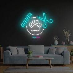 a living room filled with furniture and a neon sign