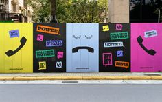 a row of colorful doors with faces and words painted on them