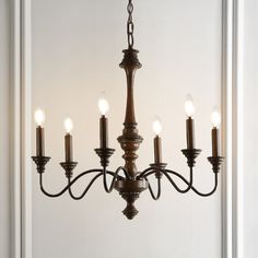 Based on historic wrought iron chandeliers, our rustic 6-light design features a quality wood-look finish. Perfectly sized for a farmhouse dining room, tall entry, or kitchen with high ceilings, our chandelier is just 25" wide and features tall candles with LED candle bulbs. Use this versatile chandelier in a modern farmhouse, French country or Tuscan style home, or to add character to a rustic, industrial space. JONATHAN Y Oakley 25" Rustic 6-Light Oil-Rubbed Black Farmhouse Bare Bulb Chandelie Midcentury Farmhouse, Kitchen With High Ceilings, Tall Candles, Tuscan Style Homes, Chandelier Farmhouse, Century Farmhouse, Wire Installation, Farmhouse French Country, Wrought Iron Chandeliers