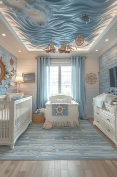 a baby's room decorated in blue and white with an ocean theme on the ceiling