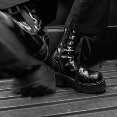 black and white photograph of someone's shoes on the ground