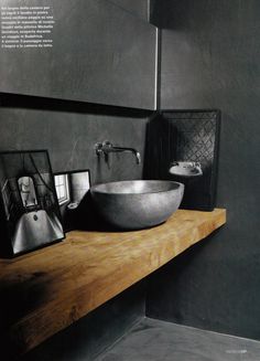 a bathroom with a large bowl sink on the counter and an ad for bewaren