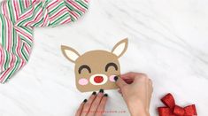 someone is making a reindeer mask out of paper