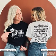 two women standing next to each other in front of a wall with the words back tour on it