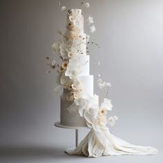 a wedding cake with white flowers on top