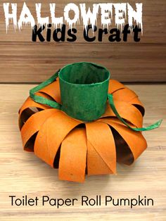 a toilet paper roll pumpkin sitting on top of a wooden table with the words halloween kids craft