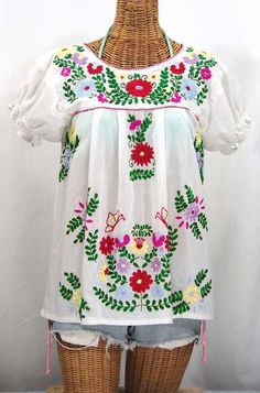 "* Ornate hand embroidery and traditional puff sleeves, available here in WHITE with BRIGHT MULTI-COLOR embroidery. * Light, gauzy and semi-sheer 100% cotton throughout; wear it billowy and flowing in the traditional bohemian style. * Dyed, distressed and embroidered entirely by hand for an authentic, retro-vintage and hippie casual vibe. * Our ornate butterfly floral embroidery patterns are a faithful tribute to the original Mexican style hippie blouses of the 1970's. * Caringly embroidered by White Puff Sleeve Tops With Embroidered Sleeves, White Peasant Top With Floral Embroidery, White Floral Embroidered Peasant Top, White Puff Sleeve Blouse With Floral Embroidery, White Embroidered Folk Peasant Top, White Cotton Peasant Top With Embroidered Sleeves, Folk Style Fitted White Embroidered Top, White Short Sleeve Blouse With Embroidered Sleeves, White Blouse With Embroidered Short Sleeves