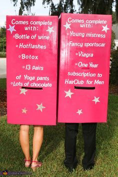 two people standing next to each other wearing pink signs