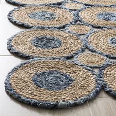 several circular rugs on the floor with blue and beige circles around them, all arranged in rows