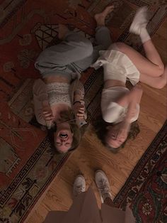 two people laying on the floor next to each other