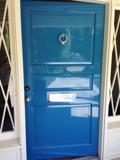 a blue front door with white trim and windows