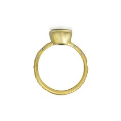 a yellow gold ring with diamonds on the top and bottom, set against a white background