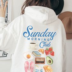 Chase away the Sunday Scaries with this comfy and casual Sunday Morning Club breakfast hooded sweatshirt. If you're a Downtown Girl with Introvert Tendencies and a weakness for coffee and waffles, this is sure to be your new favorite weekend hoodie. Exclusively designed by Parcel 23. Direct to garment printed in the USA (not a heat transfer or vinyl) Produced and delivered in about a week. You're going to love this sweatshirt! Gildan Unisex Heavyweight Blend Hoodie Classic fit, Unisex sizing.  S Comfy Hoodie With Letter Print For Loungewear, Comfy Letter Print Hoodie For Loungewear, Cozy Fit Hoodie With Letter Print, Comfy Loungewear Hoodie With Letter Print, Cozy Hoodie With Graphic Print For Loungewear, Cozy Graphic Print Hoodie For Loungewear, Comfy Hoodie Sweatshirt With Letter Print, Comfy Hooded Sweatshirt With Letter Print, Comfy Letter Print Hoodie Sweatshirt