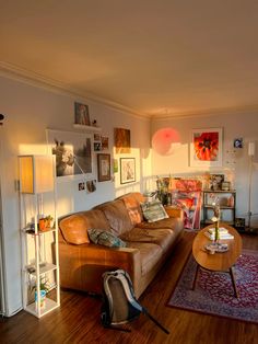 a living room filled with furniture and pictures on the wall