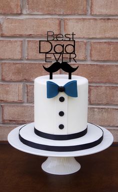 a cake with a mustache and bow tie on it