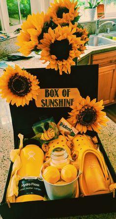 sunflowers and other items in a box on a kitchen counter with the words box of sunshine written on it