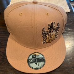 Poshmark Listing: Tan Fitted 59fifty Los Angeles Hat - Size 7 1/2 Vintage Vibes: Unleash Timeless Style With This Tan Fitted 59fifty Los Angeles Hat In Size 7 1/2. A Perfect Blend Of Classic And Contemporary Flair. Authenticity Preserved: Sporting All Original Stickers After Fourteen Years, This Hat Carries A Unique Charm That Adds Character To Your Ensemble. Ideal For Vintage Enthusiasts: Whether You're A Seasoned Collector Or A First-Time Vintage Seeker, This Hat Is Perfect For Anyone Aiming T Brown Snapback Hat For Streetwear, Brown Fitted Hat With Flat Bill For Streetwear, Brown Flat Bill Fitted Hat For Streetwear, Classic Brown Baseball Cap For Streetwear, Brown Flat Bill Baseball Cap For Streetwear, Brown Flat Brim Hat For Streetwear, Classic Brown Snapback Hat With Flat Bill, Brown Flat Brim Fitted Hat For Streetwear, Urban Brown Snapback Baseball Cap