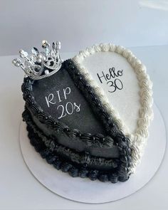 a cake decorated with black and white frosting