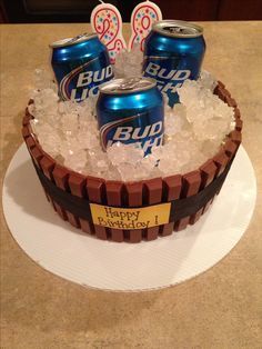 a birthday cake made to look like a barrel with ice and soda cans in it