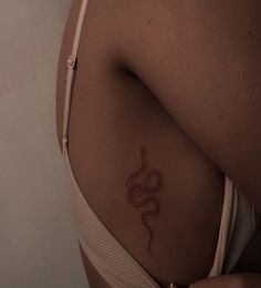 a woman with a snake tattoo on her stomach