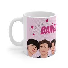 a white coffee mug with the words bang on it and three men's faces