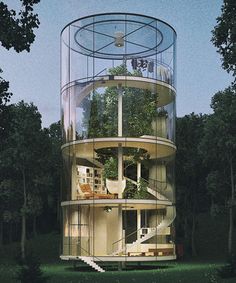 a tall glass tower sitting in the middle of a forest