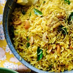 a bowl filled with rice and vegetables on top of a table