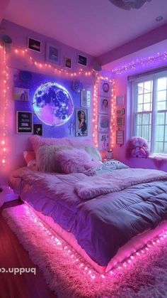 a bedroom with purple lights and pink bedding