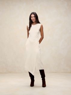 We selected one of our favorite all-season yarns for this long midi dress, employing a half-Milano stitch for its smooth handfeel and soft structure.  Column fit.  Crew neck.  Wrap-front detail.  Unlined.  Column fit.  Sleeveless.  Midi length.  Model: Size S, 5'10" (178cm). Elegant Midi Dress With Asymmetrical Hem For Work, Solid Knee-length Midi Dress With Side Slits, Knee-length Midi Dress With Side Slits, Beige Midi Dress With Side Slits, Sleek Midi Dress With Side Slits For Work, Modern Sleeveless Maxi Dress For Work, Chic Knee-length Midi Dress With Side Slits, Fall Workwear Midi Dress With Side Slits, Solid Viscose Dress For Workwear